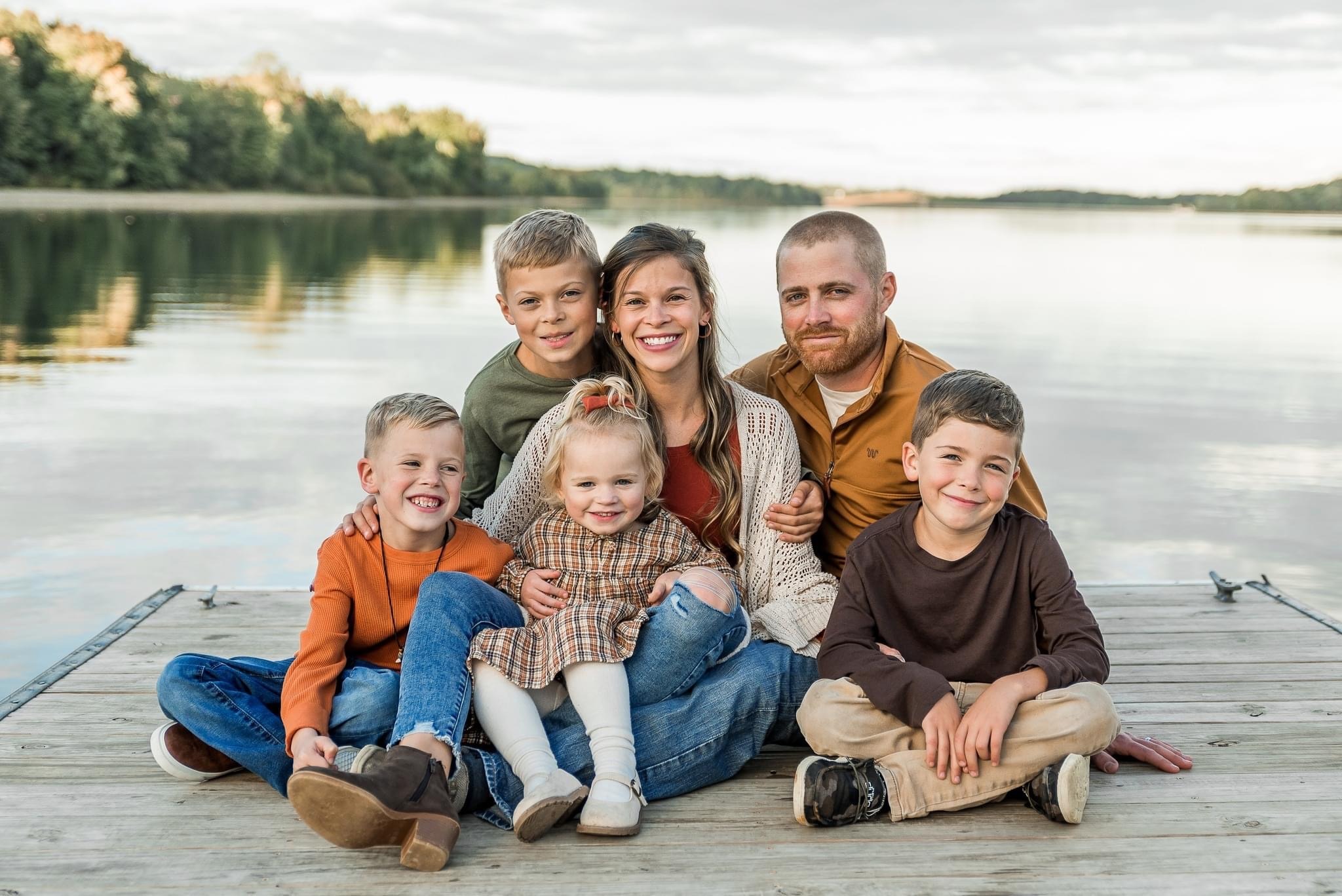 Trey Chilcoat and his family on a pier with water in the background